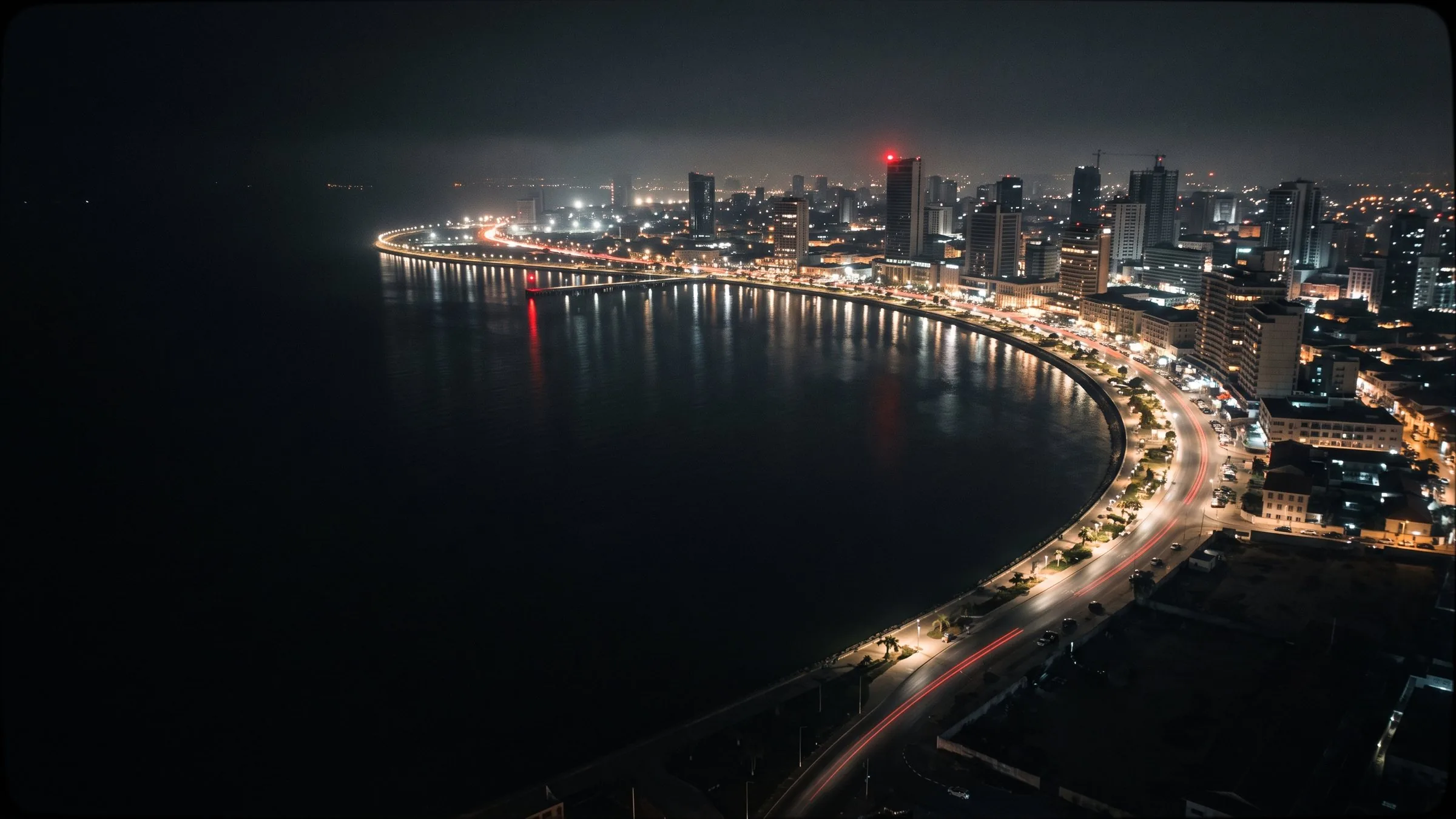 Luanda bay at blue hour, the city lights reflected in the water
